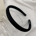 Detail of handmade black fabric headband with satin texture on elegant glass base - Black