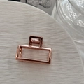 Close-up of a rectangular rose gold alloy hair claw clip with a sleek hollowed-out design - Square Rose Gold