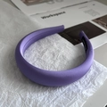 Detailed macro view of purple sponge headband featuring a hand-made label and silk texture - Purple