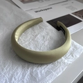 Detail of olive green satin padded headband with a handmade woven label on inner side - Mustard Green