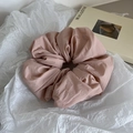 Macro detail of dusty pink oversized scrunchie fabric texture on a minimal white backdrop - Pink