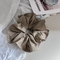 Detailed close-up of khaki fabric scrunchie showing fine texture and sewing craft - Khaki