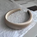 Detailed macro view of the champagne satin wide headband with handmade woven label - Light Khaki