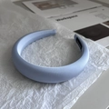 Detailed close-up of a light blue padded headband made of smooth, glossy silk material - Blue Gold