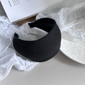Detailed view of wide knitted black headband with premium ribbed texture and chic style - Black