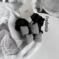 Set di due elastici per capelli neri con fiocchi a scacchi bianchi e neri su carta - Collana a mini fiocco
