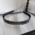Diadema negra elegante con brillantes pedrería plateada sobre bandeja de cristal - Color gunmetal