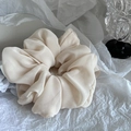 Detail of a jumbo cream white scrunchie in soft chiffon fabric with delicate pleats - Beige