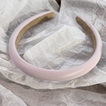 Close-up of pink padded leather headband with soft anti-slip lining and matte finish - Light Purple