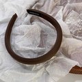 Detail of dark brown fabric headband featuring a woven texture and handmade textile label - Coffee