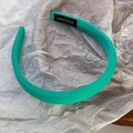 Detail showing the handmade label and ribbed mint green fabric on thick headband - Green