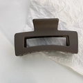 Macro detail of a large matte chocolate brown rectangular hollow hair claw clip - Brown