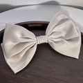 Detailed close-up showing the glossy silk satin texture of the large bow hair clip - Double Layer Bow ~ Apricot