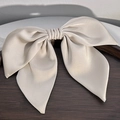 Detailed view of elegant champagne satin bow hair clip with refined silk texture - Apricot Bowknot