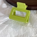 Detail shot of bright green matte square claw clip on white textured background - Small Square