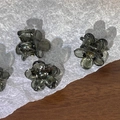 Detail of four smoky grey mini flower hair claws with translucent resin finish - Gray
