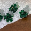 Close-up of mini flower hair claw in dark green resin with golden spring on paper - Dark Green