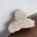 Detailed close-up of a plush beige hair claw clip with soft faux fur texture for winter - Milk White