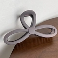 Detailed macro view of matte grey-purple hair claw clip with internal metal spring structure - Purple Grey