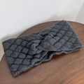 Detail of cross-knot design on dark grey chunky knit headband with diamond pattern texture - Gray