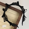 Vintage black polka dot mesh headband with elegant satin bows on a velvet tray - Black
