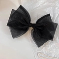 Elegant triple-layered black organza bow hair clip for women with pearls in background - Black