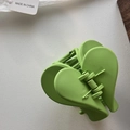 Detail view of avocado green matte heart-shaped shark hair claw clip accessory - Green