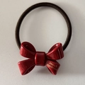 Handmade red bow hair tie with glossy finish and brown elastic band for ponytails - Red
