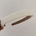 Detail view of the beige plaid fabric headband with non-slip brown suede lining - Beige