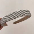 Detail of black and white tweed fabric texture on a padded vintage sponge headband - Black