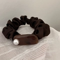 Detail of coffee brown satin scrunchie with marble resin accent and white pearl - Amber