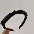 Detail of a black knotted headband made of premium satin fabric with elegant silk sheen - Black