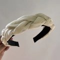 Detailed view of beige braided headband featuring woven chiffon fabric and black comfort tips - Apricot