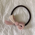 Close-up of acetic acid bow hair scrunchie with pink marbled texture on high elastic band - Pink White