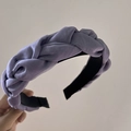 Detail view of purple woven headband with satin texture and twisted braid design - Purple