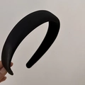 Close-up of a wide padded black headband showing soft matte fabric and sponge texture - Black