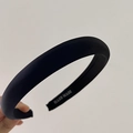 Detail of a padded black headband with high-quality fabric texture and Hand Made label - Black