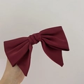 Detail of a large burgundy satin bow hair clip with handmade layered ribbon texture - Burgundy