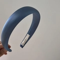 Detail of a thick navy blue matte satin headband with inner label and padded sponge core - Navy Blue