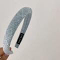 Detailed shot of quilted light blue denim headband with Hand Made woven label inside - Blue