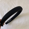Detail of handmade black padded headband showing soft fabric texture and hand made label - Black