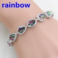 Detailed view of silver chain bracelet featuring teardrop rainbow gemstones and small crystals - Rainbow