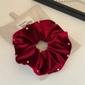 Detailed close-up of dark red velvet scrunchie with pearls next to a linen pouch - Single Layer Red Velvet (FQ-0996)