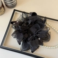 Dettaglio dell'elastico in organza nera con piccoli fiori bianchi e fiocchi chic - Nero