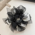 Detail view of double-layer polka dot mesh scrunchie with organza texture and retro design - White Polka Dot Lace