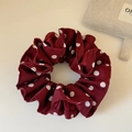 Detailed view of burgundy red satin hair scrunchie with white polka dots texture - Red Big Polka Dots