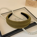 Detailed view of an olive green knit wide headband with thick padded texture for women - Green