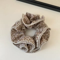 Detail of floral scrunchie with brown and pink patterns and beige stitched edges - Beige Four-Layer Floral