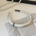 Macro shot of white satin headband with rhinestone buckle and handcrafted label detail - Off-white