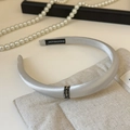 Close-up of silver-gray satin headband featuring three rows of sparkling diamond-set metal rings - Blue Grey